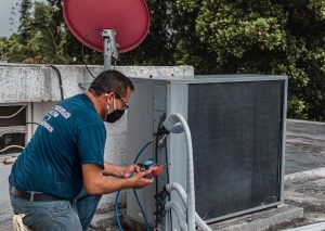 Reliable AC technician repairing an air conditioner compressor in Phoenix